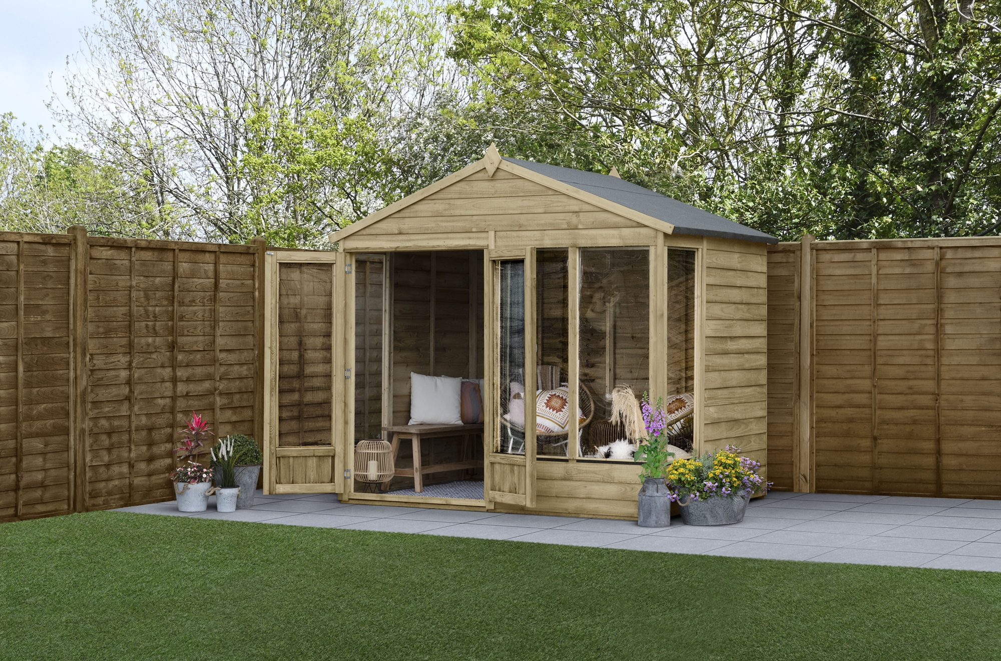 A brown wooden summerhouse is located in a garden. The shed has two doors and four windows. A wooden fence runs along the edge of the garden.