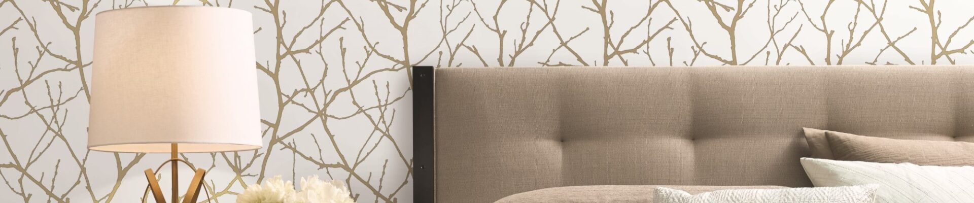A nature-inspired wallpaper on a bedroom wall