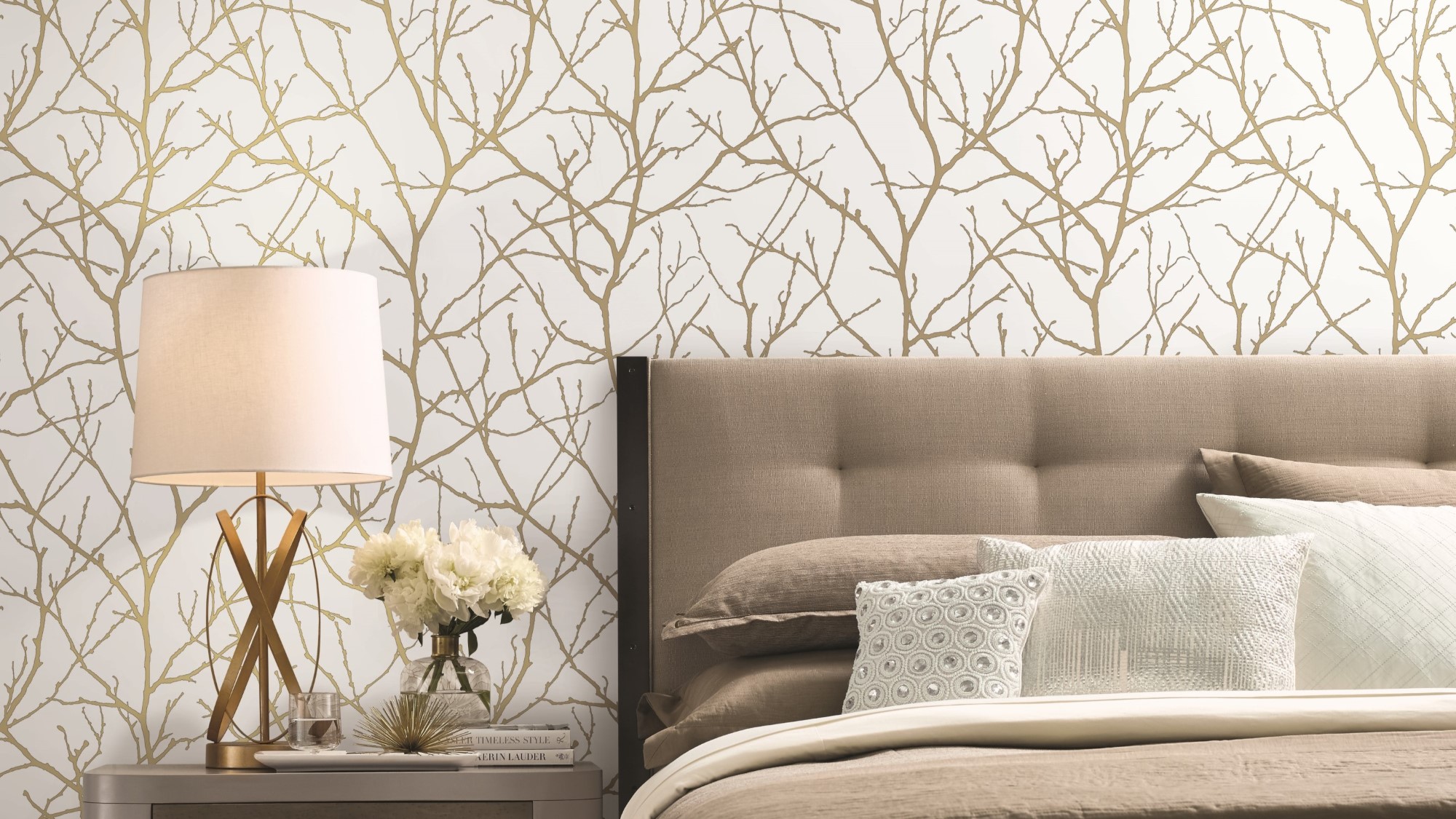 A nature-inspired wallpaper on a bedroom wall