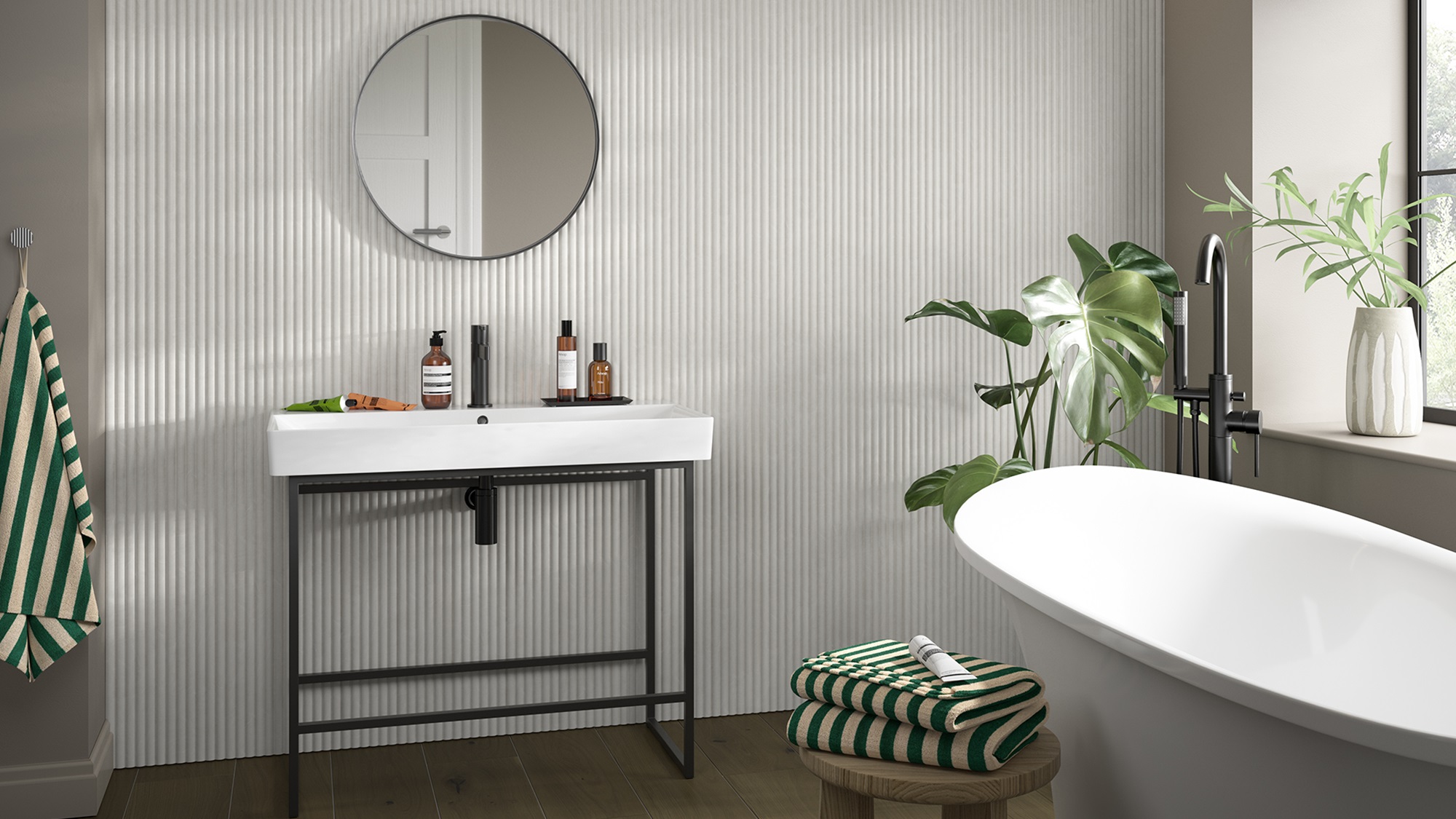 A small bathroom featuring modern reeded wooden wall-panelling with a white sink, mirror, and bathtub.