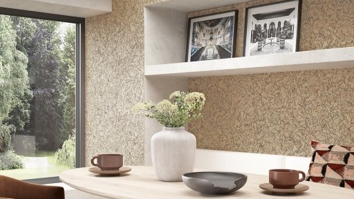 A modern kitchen with cork panelling on the walls.
