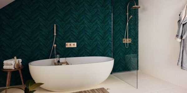 A white bathtub with a chrome taps and showerhead mounted on the wall next to it. The bathtub sits on the floor of a bathroom with bold walls and tile flooring