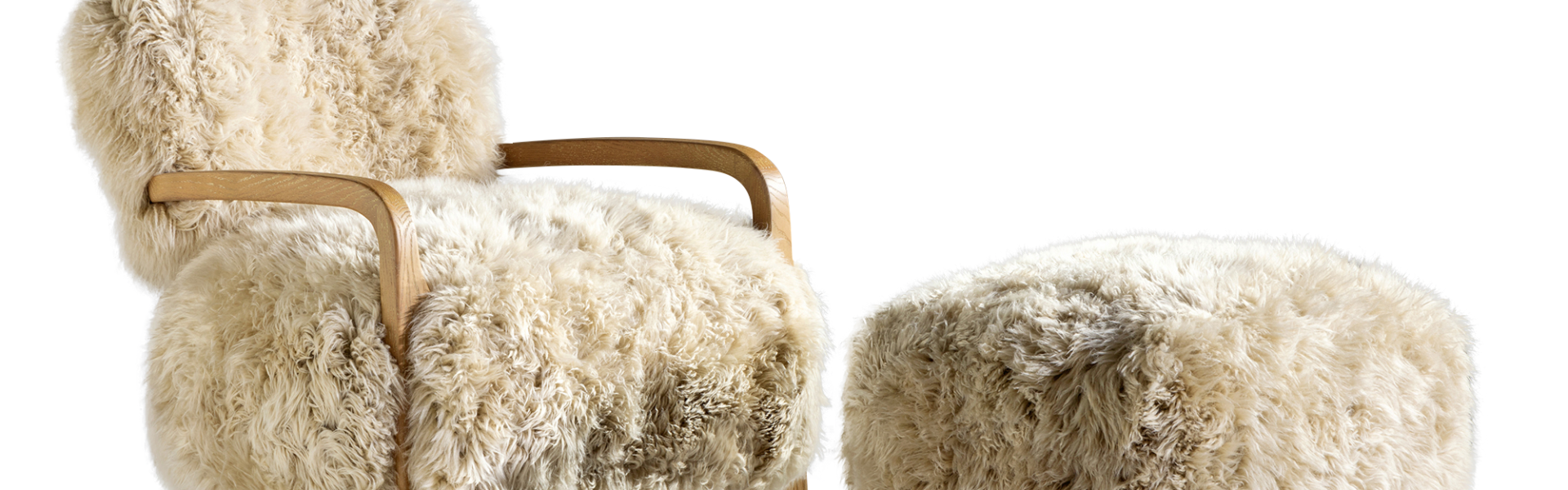A luxurious white fur chair and footrest set against a crisp white backdrop.