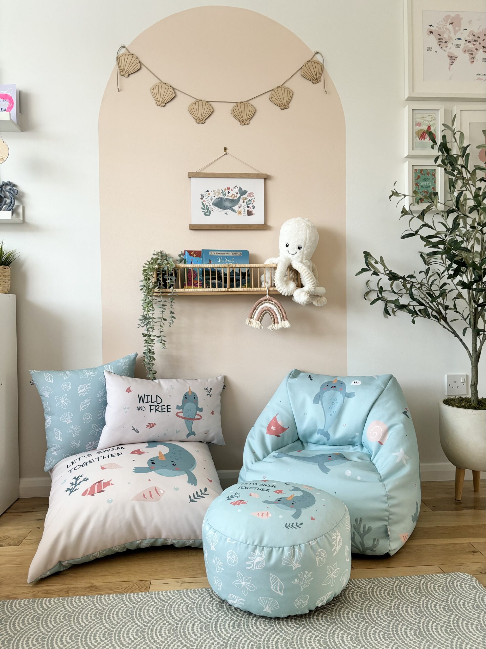 A cosy room with a beanbag chair, ottoman, and pillows.