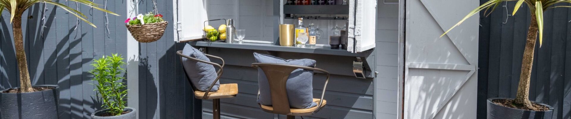 Image of a colourful outdoor bar which has been painted in a classic grey shade