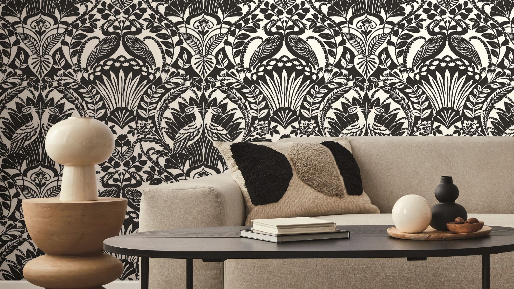 A detailed portion of wallpaper, highlighting an intricate pattern of large, exotic leaves in various shades.