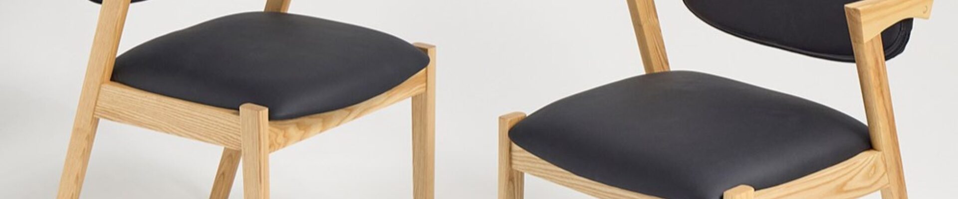 Two modern dining chairs with a clean and minimalist design