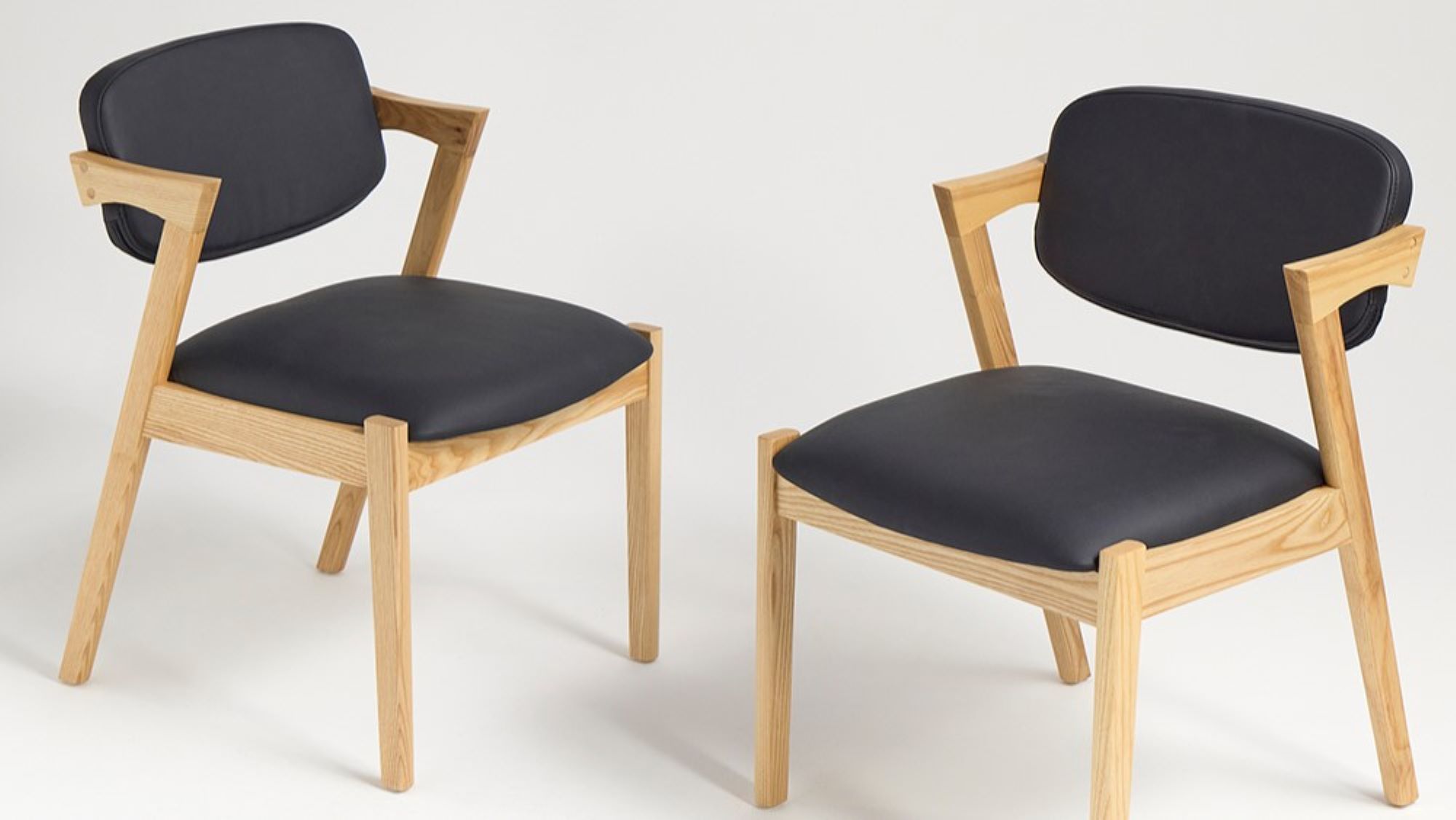 Two modern dining chairs with a clean and minimalist design