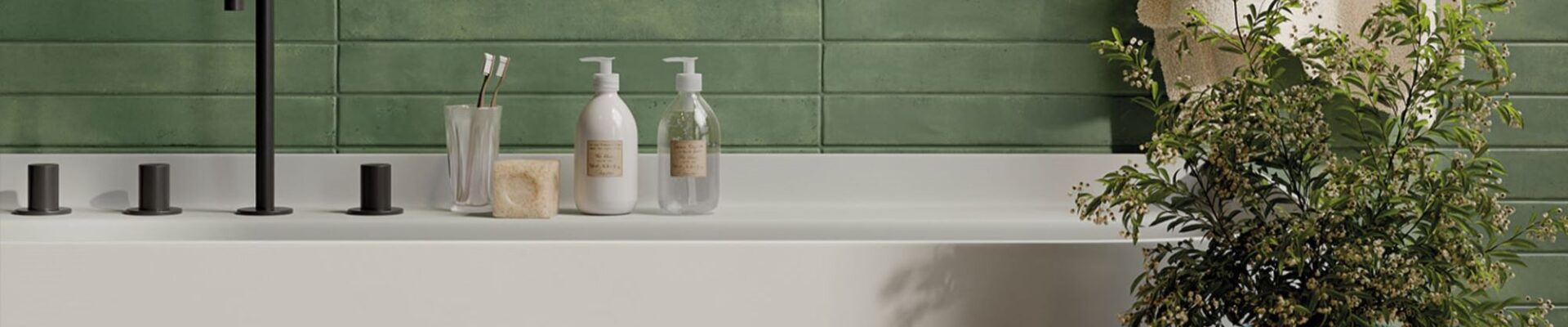 The image shows a modern bathroom with a white bathtub, a green tiled wall, and a variety of accessories, including a plant, towels, and a soap dispenser. The overall aesthetic is clean, minimalist, and inviting.