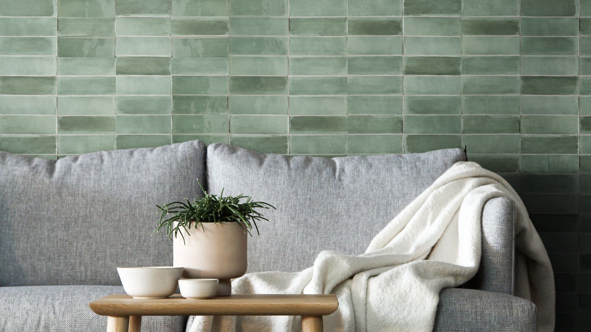 A beautiful green tile backsplash creates a calming and inviting atmosphere in this living room