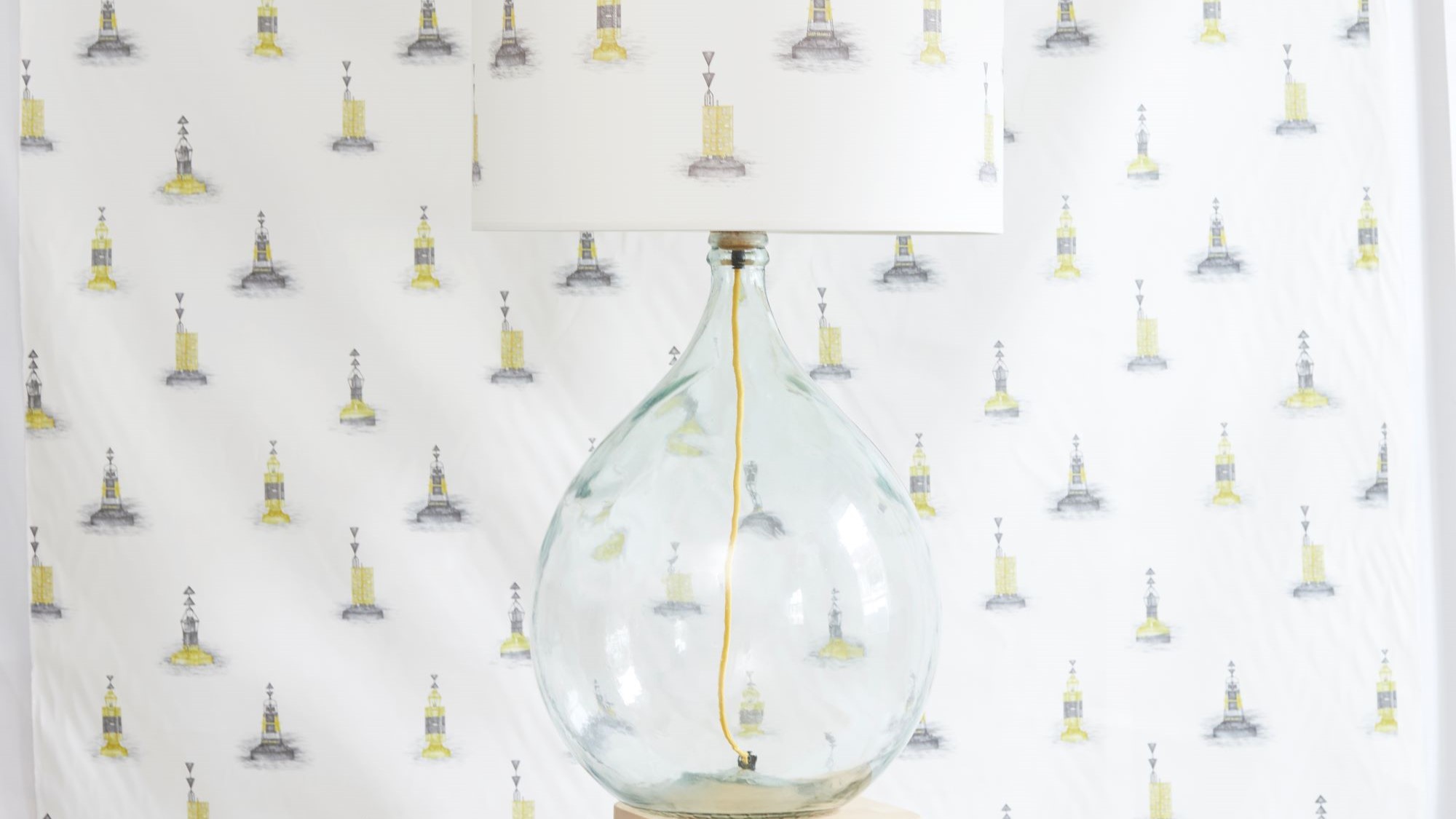 Made from a large, clear glass bottle. The bottle has a rounded, bulbous shape, giving it a distinctive look. The base is likely repurposed from a wine or liquor bottle.