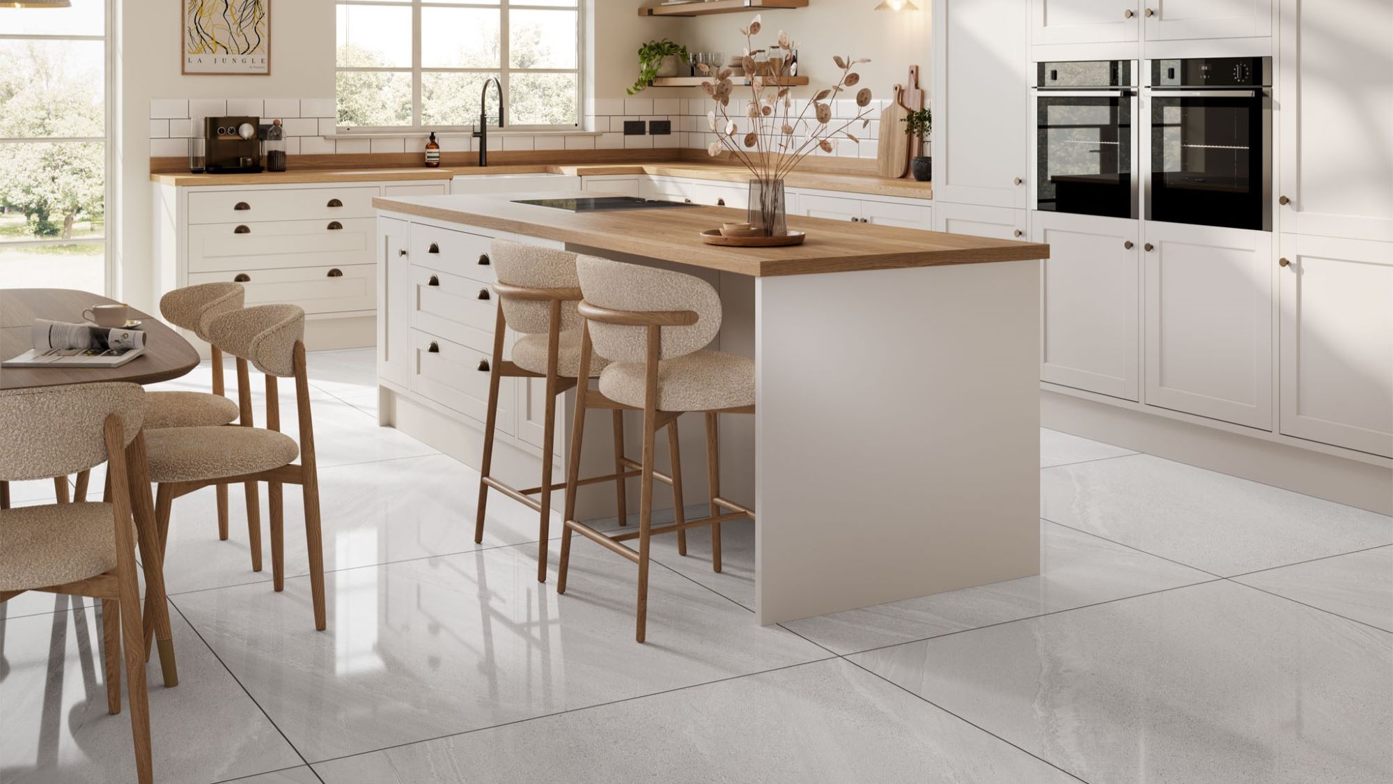 A spacious and stylish kitchen with a large island and a dining area. The kitchen has a modern design with white cabinets, a wooden countertop, and a white tile floor.