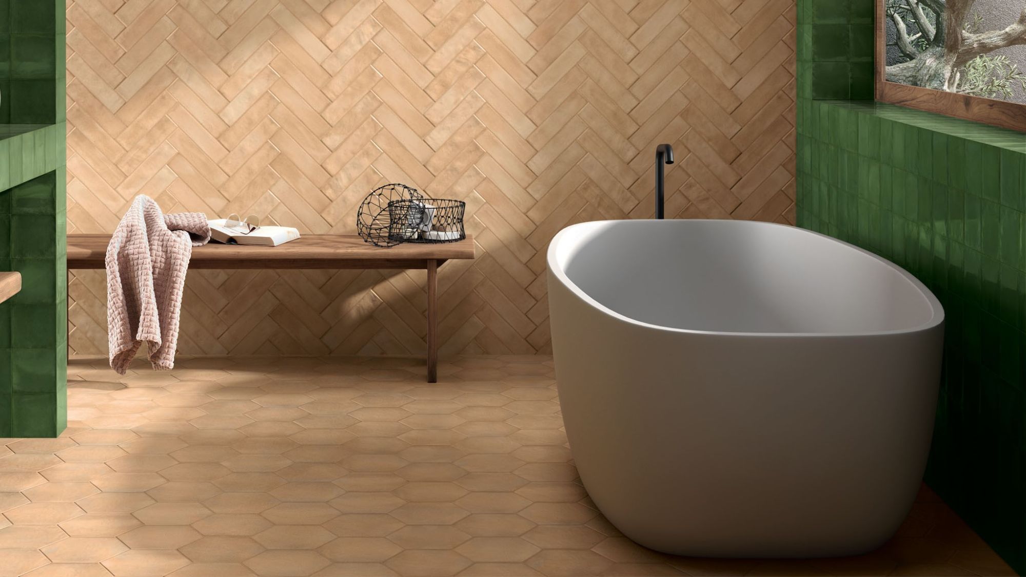 Modern bathroom with a freestanding white tub and a herringbone terracotta tile wall.
