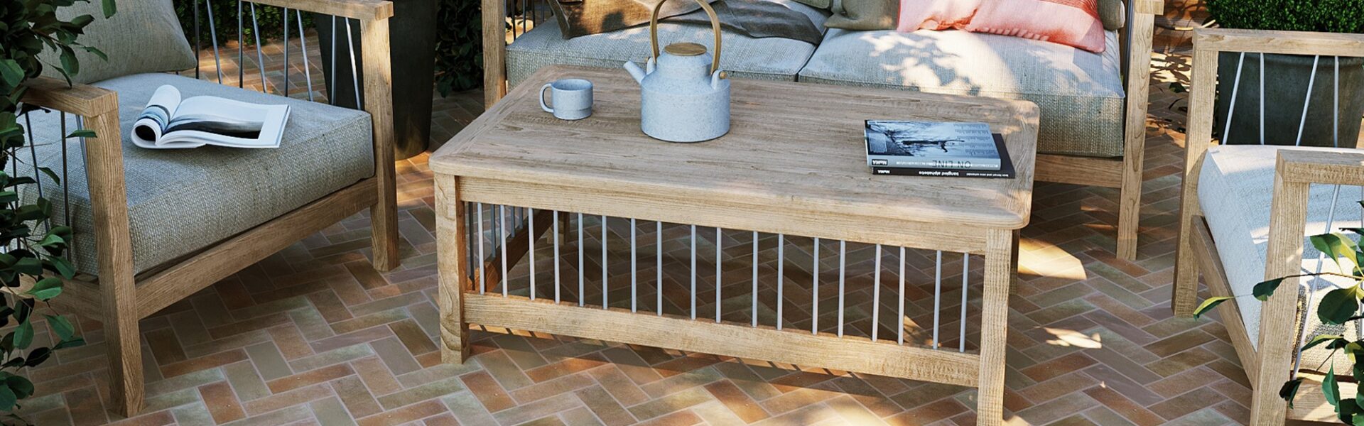 The patio features herringbone-patterned terracotta tiles in warm, earthy tones, creating a visually appealing surface.