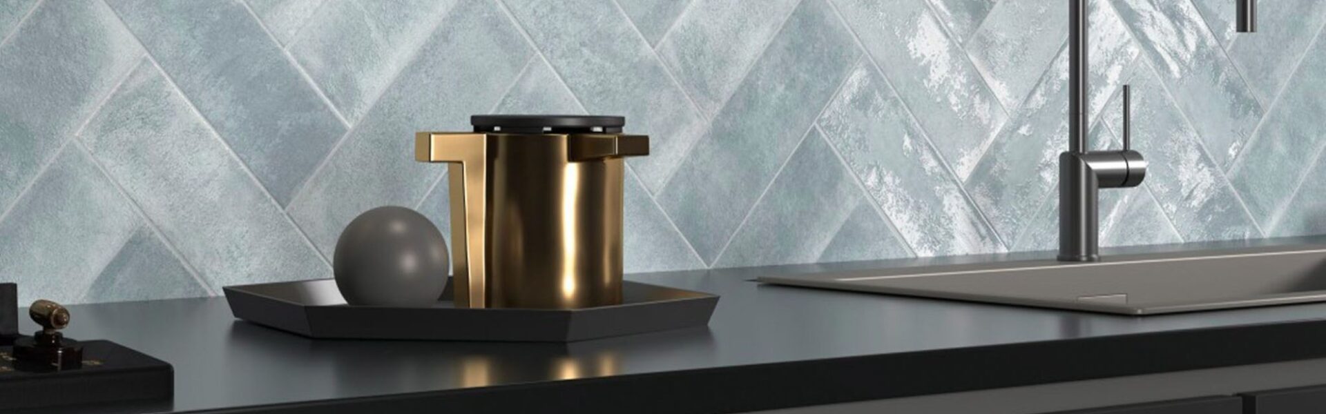 The backsplash features light blue or grey tiles arranged in a herringbone pattern. The tiles have a distinctive textured, almost wavy or rippled surface, giving them a handmade or artisanal appearance.