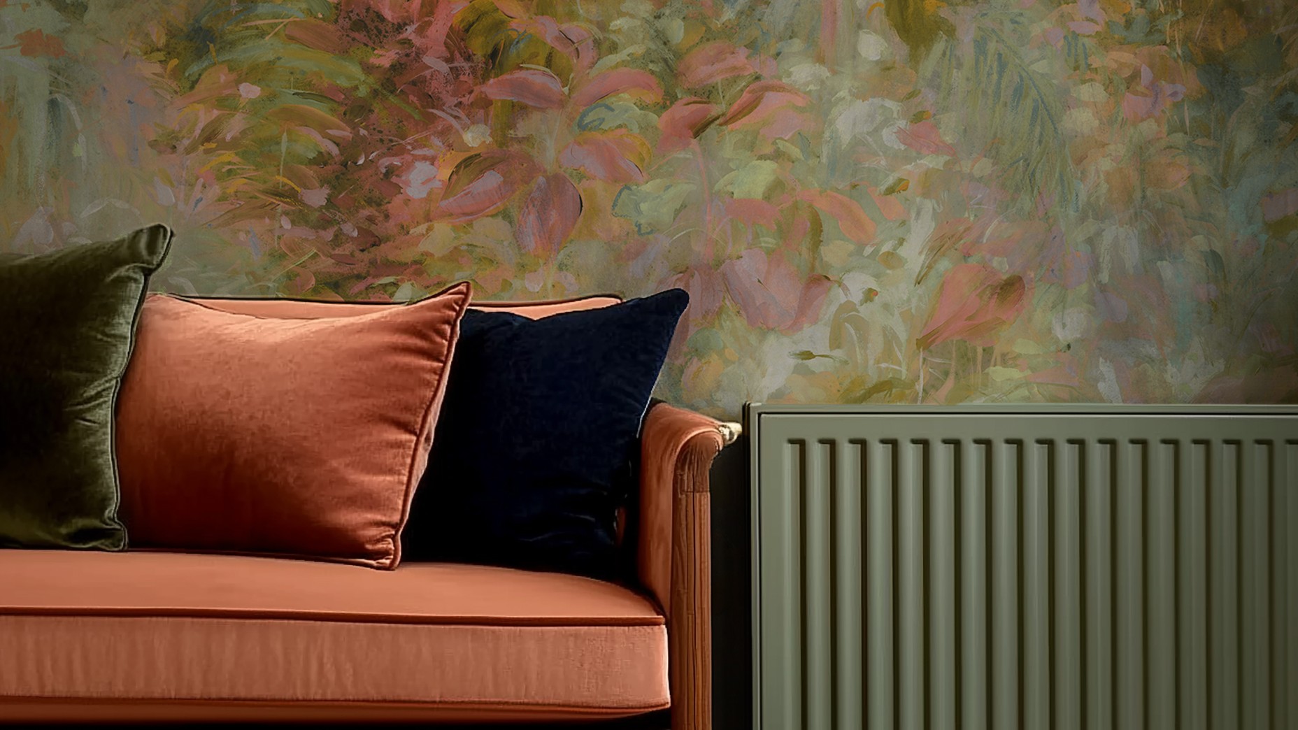 The wallpaper behind the sofa and radiator features a painterly floral design. The colours are soft and muted, with shades of pink, green, and a hint of yellow. The pattern appears abstract, with blurred edges and a watercolour-like quality.