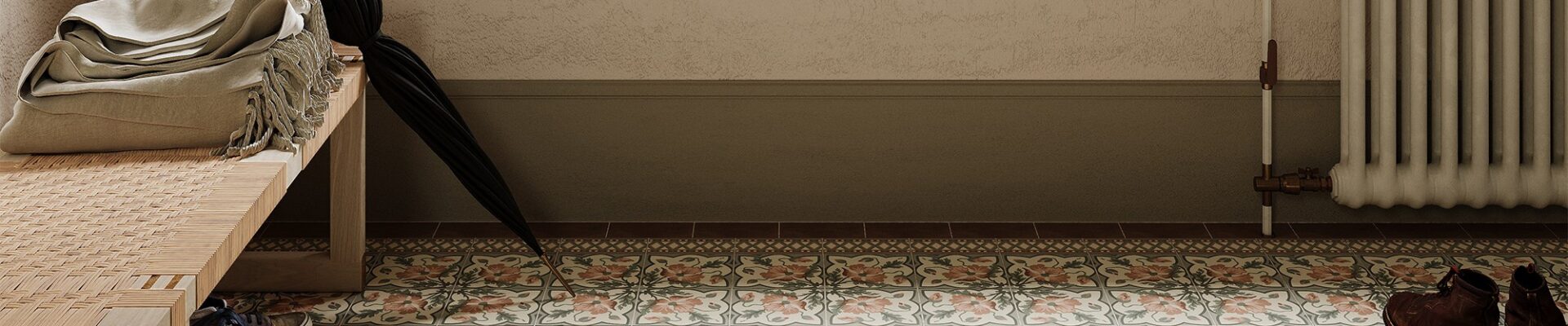 A brightly lit entryway features patterned floor tiles in muted pink, grey, and cream, arranged in repeating floral and geometric designs.