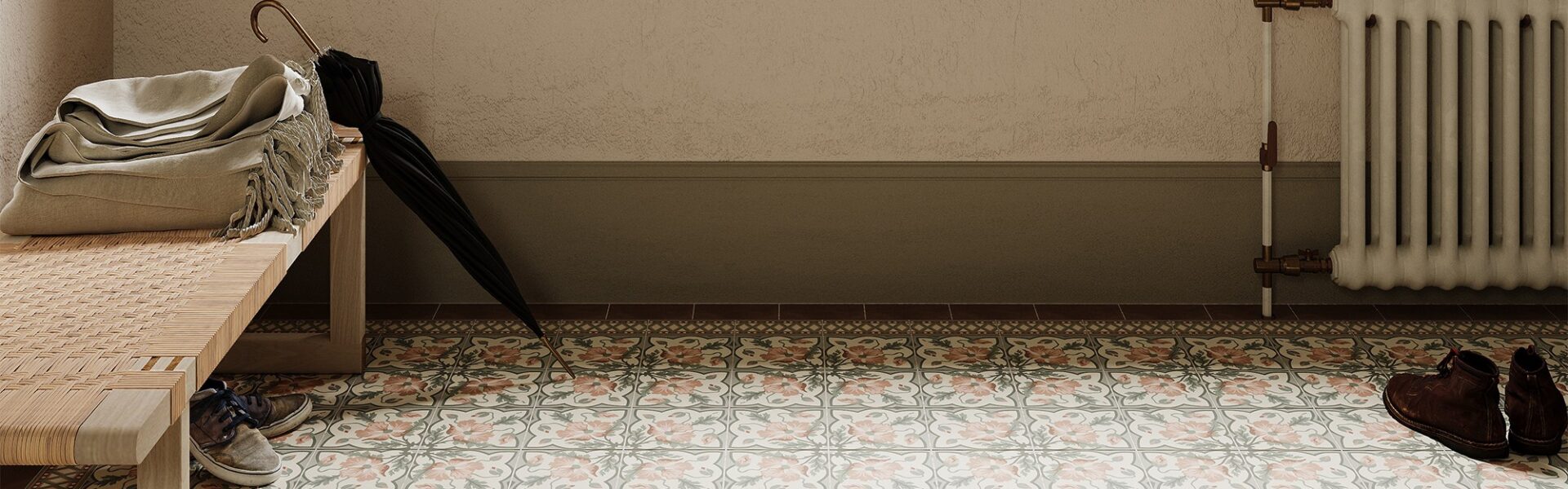 A brightly lit entryway features patterned floor tiles in muted pink, grey, and cream, arranged in repeating floral and geometric designs.