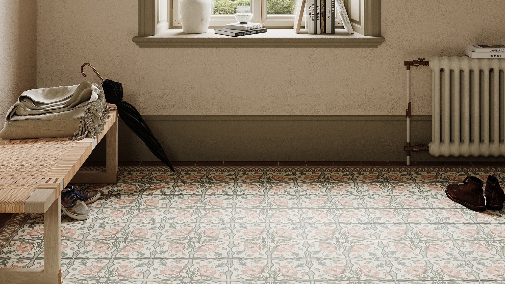 A brightly lit entryway features patterned floor tiles in muted pink, grey, and cream, arranged in repeating floral and geometric designs.