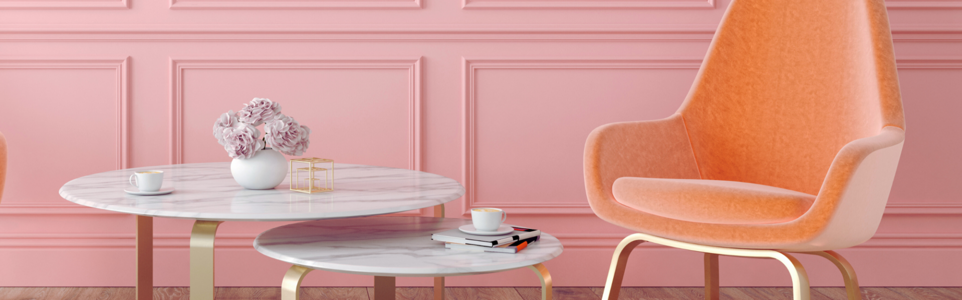 A pink panelled wall adds a touch of elegance, and the light wood flooring keeps everything feeling airy.