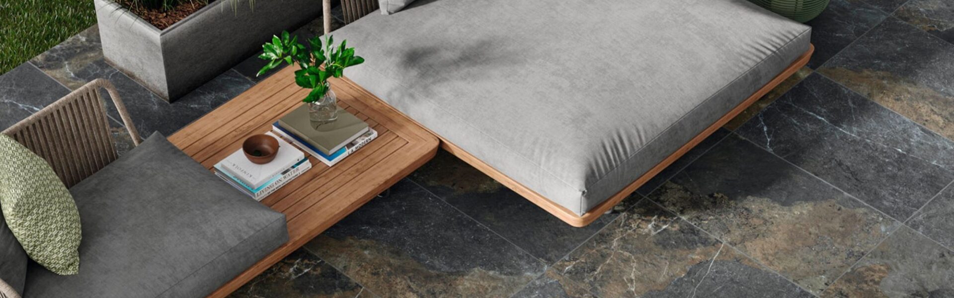 A luxurious outdoor living space featuring dark, multi-toned patio tiles.