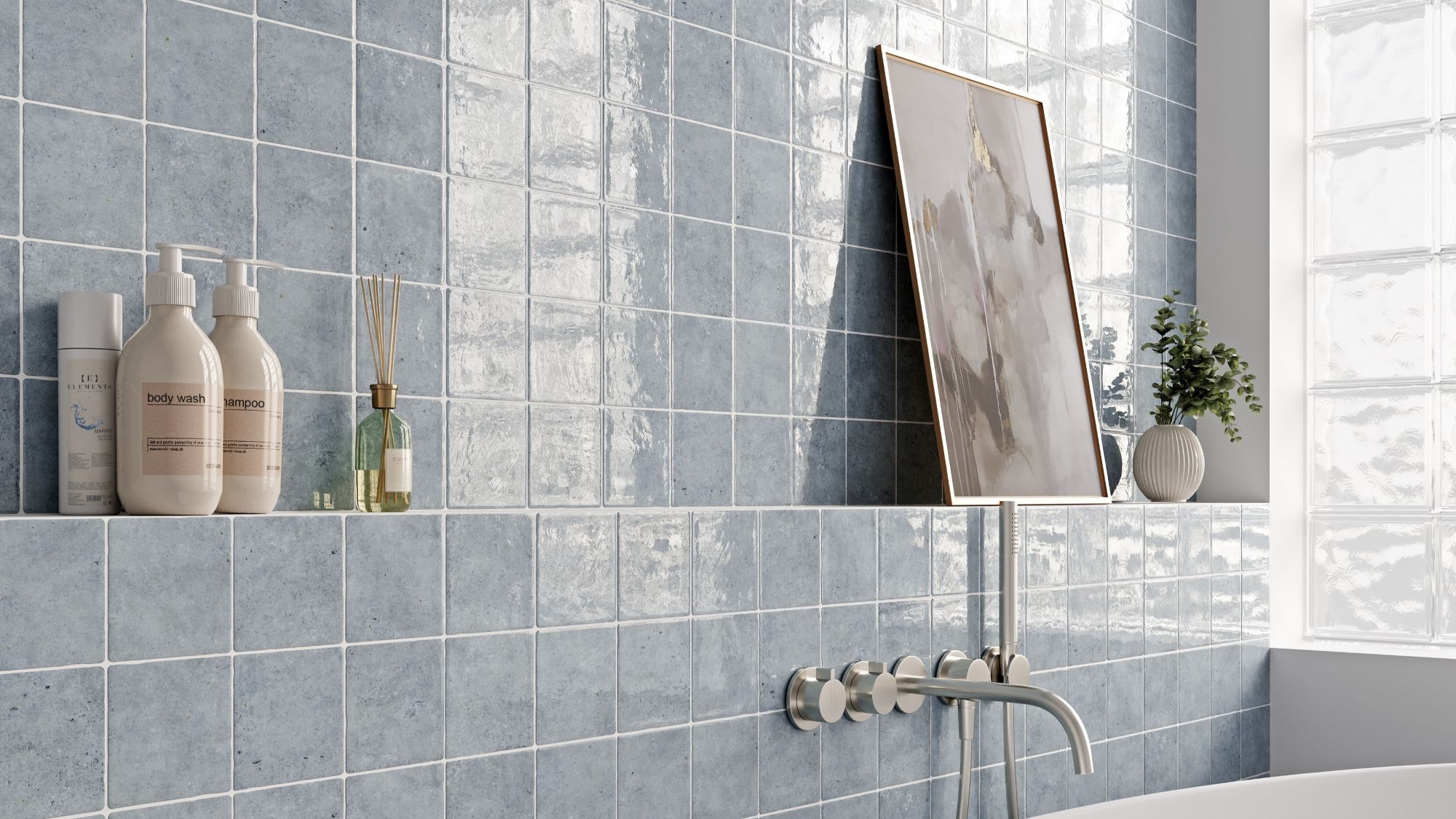 A bathroom scene featuring light blue, square wall tiles with a glossy, uneven surface. The tiles are arranged in a grid pattern with white grout lines.