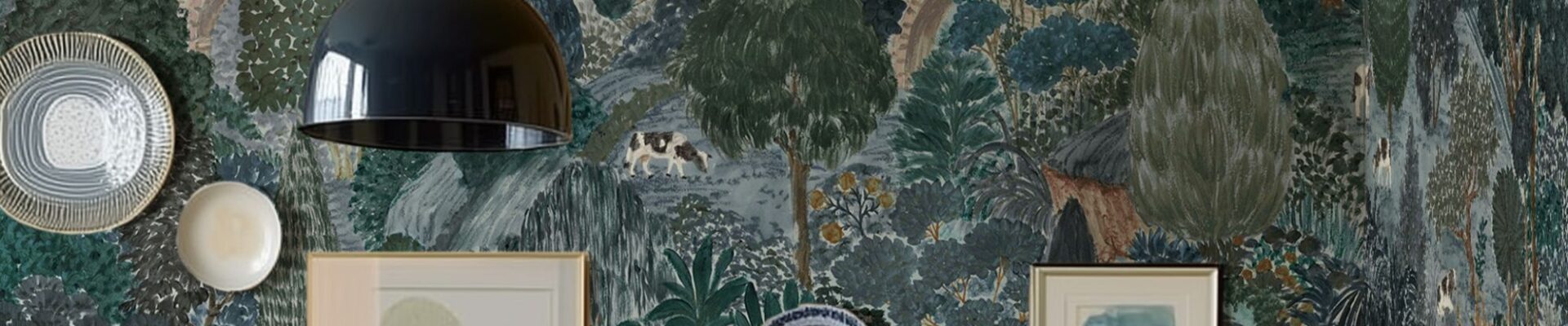 A beautifully decorated room featuring a wall adorned with a whimsical, illustrative wallpaper depicting a pastoral scene. The wallpaper, in shades of blue, green, and brown, shows rolling hills, trees, a bridge, and various animals like horses, sheep, and a cow.