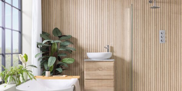Image shows a bathroom with light wood wall panels laid vertically in a slatted effect.