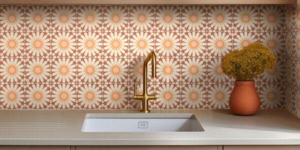 The backsplash is covered in ceramic tiles with a repeating floral pattern. The tiles are a warm terracotta colour with a large, stylized daisy design in the centre of each one. The daisy petals are a light cream or off-white, and the centres are a soft pink.