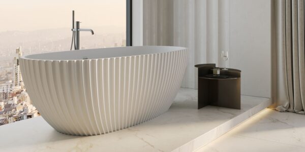 A luxurious and modern bathroom setting, dominated by a large, freestanding bathtub.