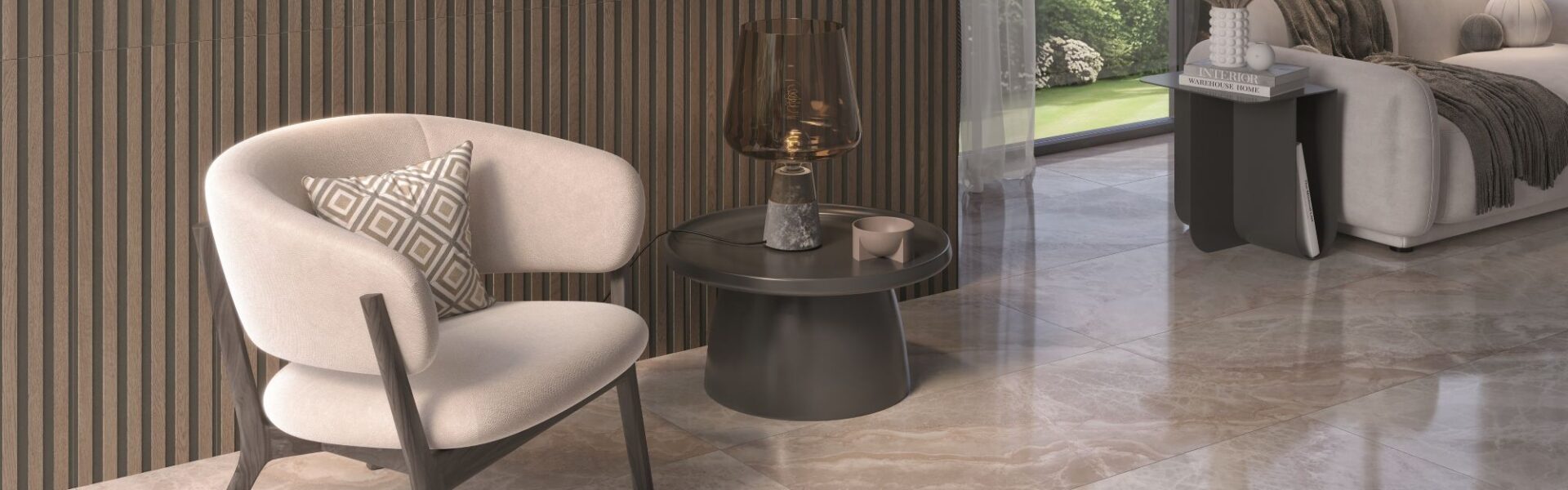 A luxurious, modern living space featuring a creamy white upholstered armchair, a ribbed wood accent wall, and glossy light-brown marble-look floor tiles. A dark round side table with a decorative lamp sits next to the chair, and a large window looks out onto a green garden.