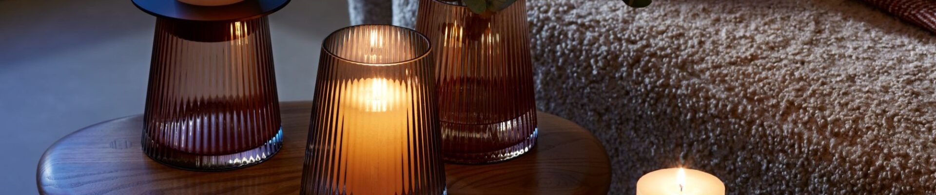 A beautiful arrangement of LSA International glassware and candles, creating a warm and cozy atmosphere.