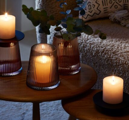 A beautiful arrangement of LSA International glassware and candles, creating a warm and cozy atmosphere.