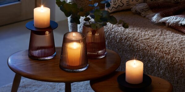 A beautiful arrangement of LSA International glassware and candles, creating a warm and cozy atmosphere.