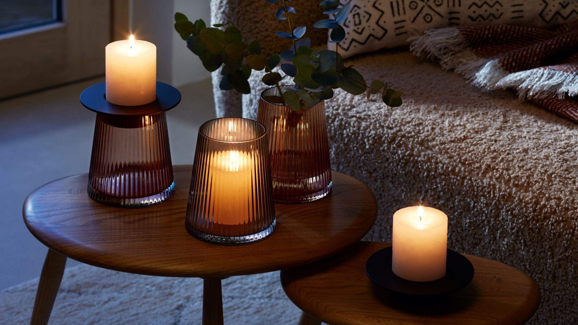 A beautiful arrangement of LSA International glassware and candles, creating a warm and cozy atmosphere.
