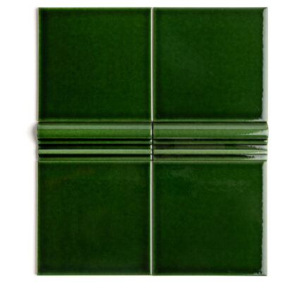 A rich, dark, emerald green tile with a high-gloss finish and dado detailing
