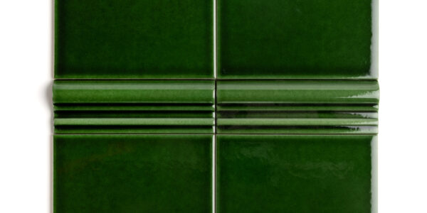 A rich, dark, emerald green tile with a high-gloss finish and dado detailing