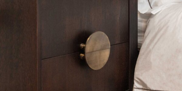 A Solid Brass Half Moon Handle in an Antique Gold or Brushed Brass finish. These handles are typically sold as a pair, allowing them to be mounted back-to-back to form a full circle, as seen in your image on the two drawers of the dark wooden cabinet.