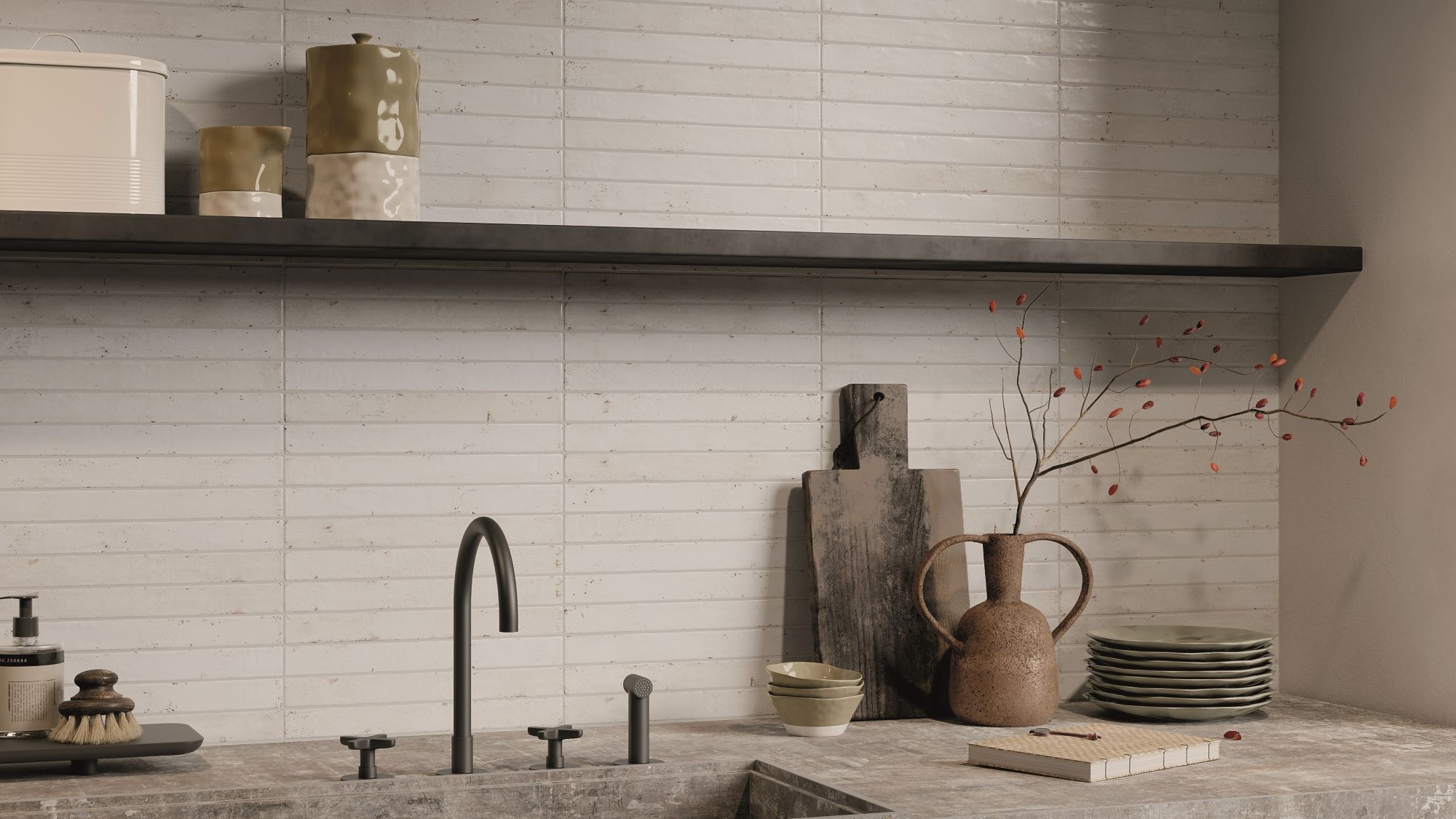 A kitchen splashback with light-coloured, rectangular tiles laid in a horizontal pattern, likely a subway or brick-style layout. The tiles appear to have a handmade or distressed texture with slight variations in colour and surface, giving them an artisan feel. They look like a creamy white or very pale beige/grey.
