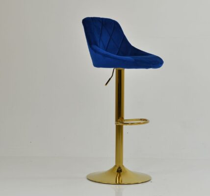 A modern blue velvet bar stool with a diamond-quilted backrest and a polished gold pedestal base.