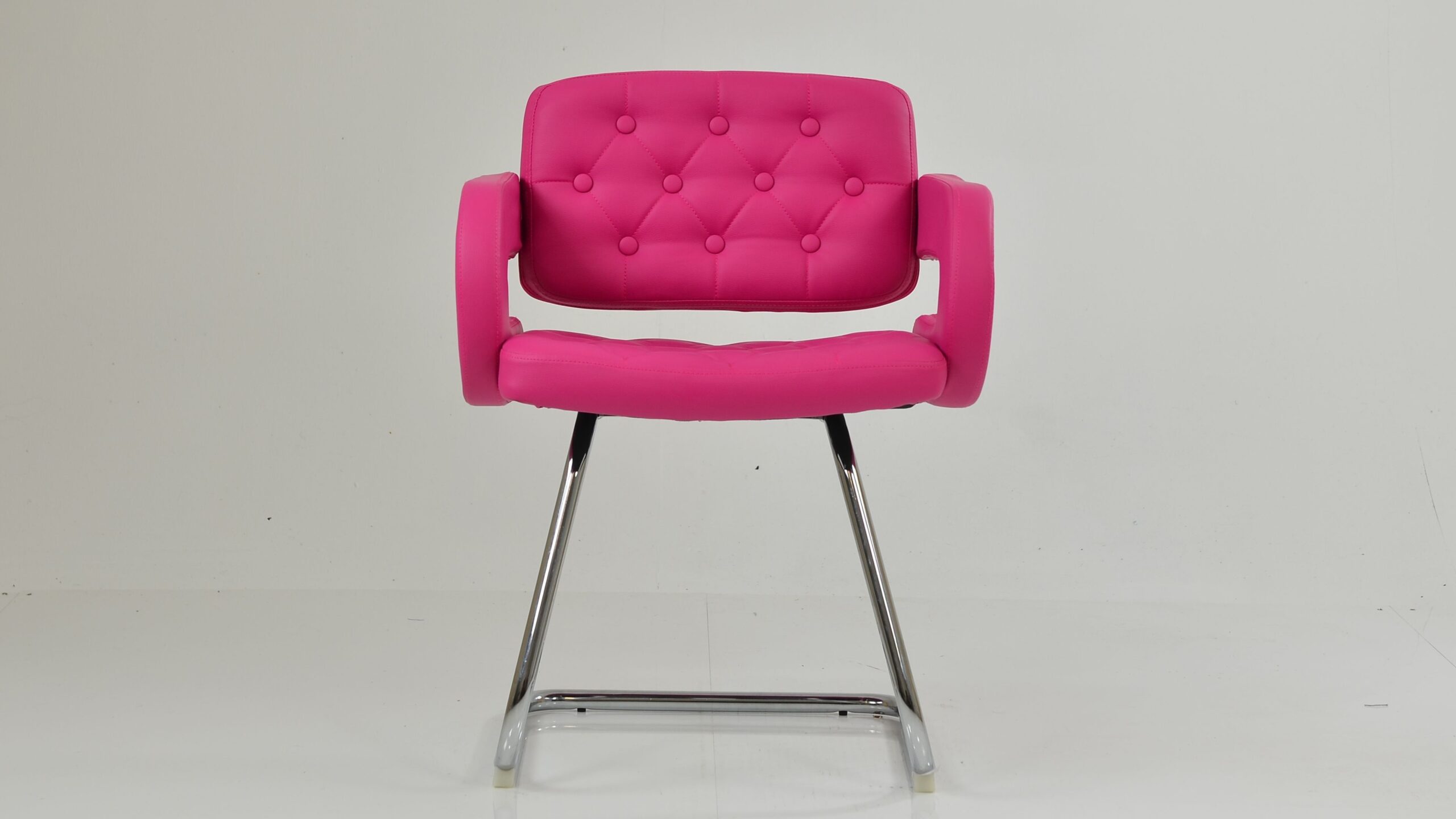 A modern Parga office chair featuring vibrant hot pink leather upholstery with button tufting and a sleek chrome sled-style base.