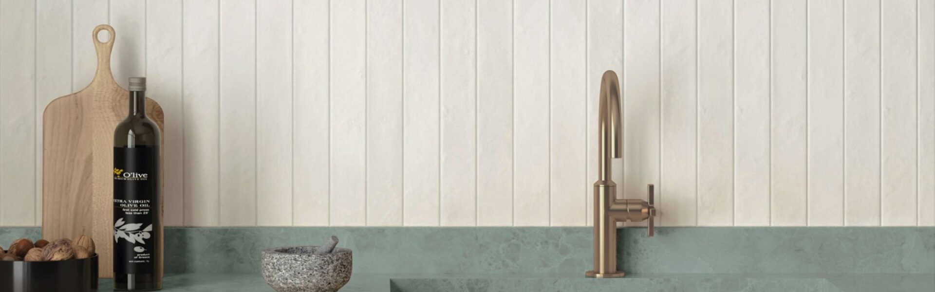 An eye-level, horizontal shot of a modern, minimalist kitchen features a vertical stack-bond backsplash made of textured, off-white rectangular tiles.