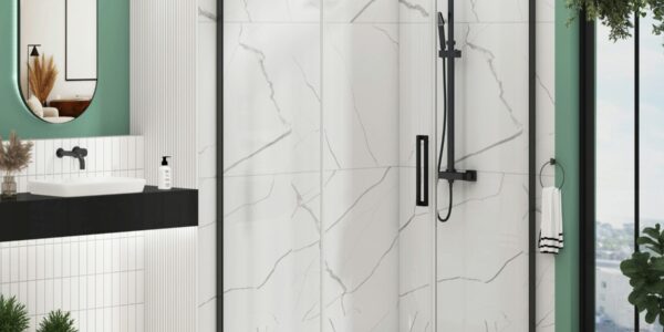 An offset quadrant shower enclosure with matt black frames and a single sliding door, installed in a modern bathroom. The enclosure features 8mm clear glass and is set against white marble-effect wall tiles.