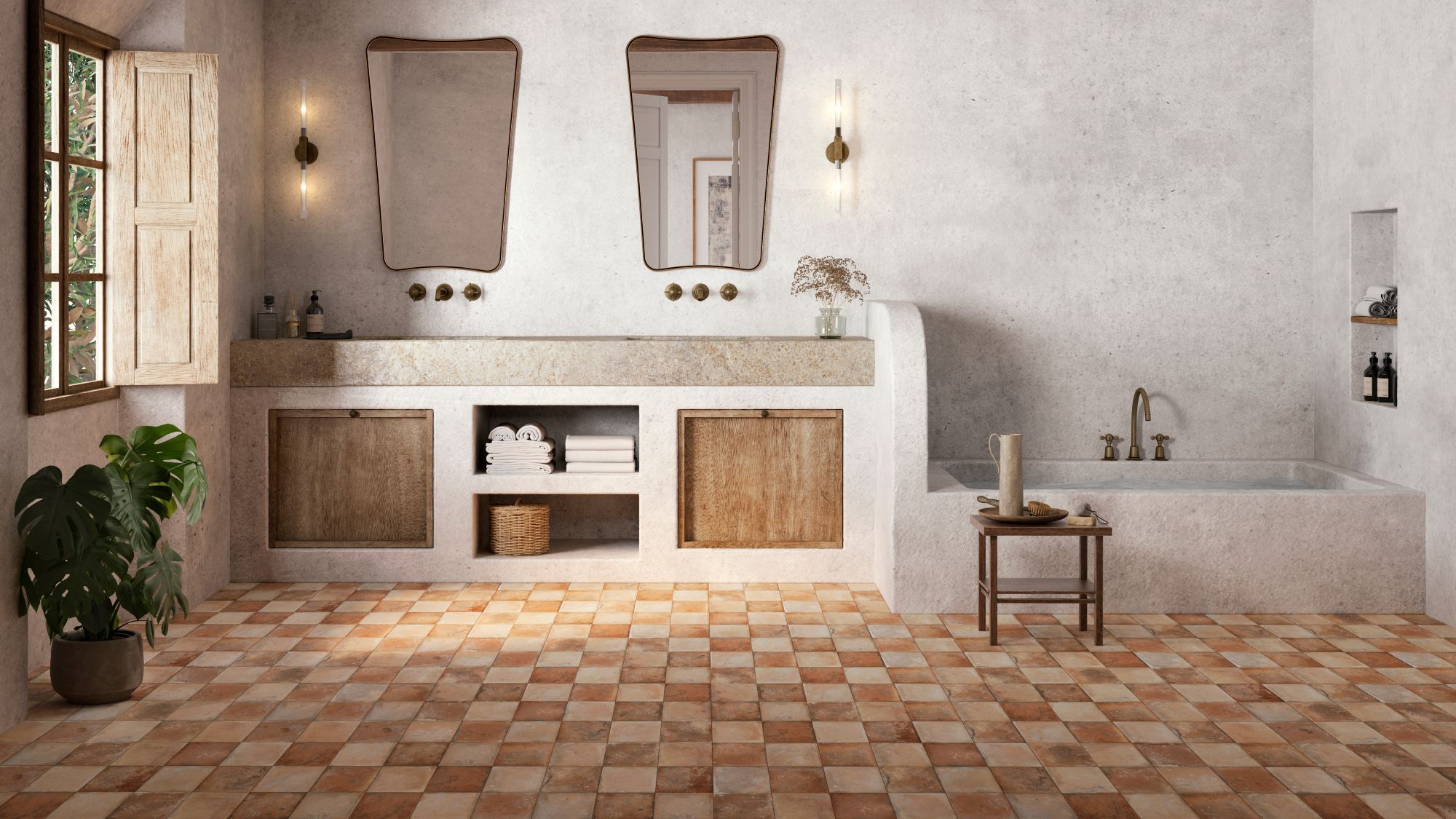 An interior photograph of a spacious, rustic-style bathroom featuring earthy tones and Mediterranean influences. The foreground is dominated by a chequerboard pattern of terracotta floor tiles in varying shades of burnt orange, tan, and cream.