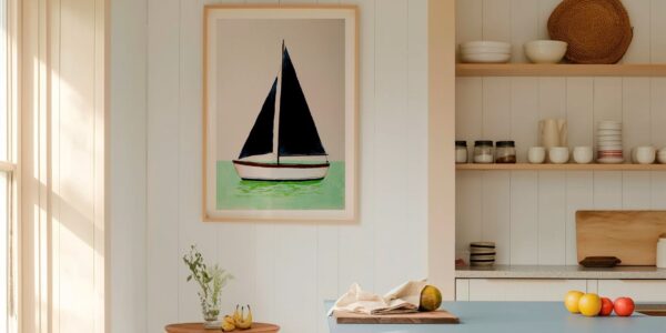 A framed art print of a minimalist sailboat with dark navy blue sails, floating on mint green water against a light beige background. The vertical print is housed in a light wood frame and hangs on a white, vertical-shiplap wall.
