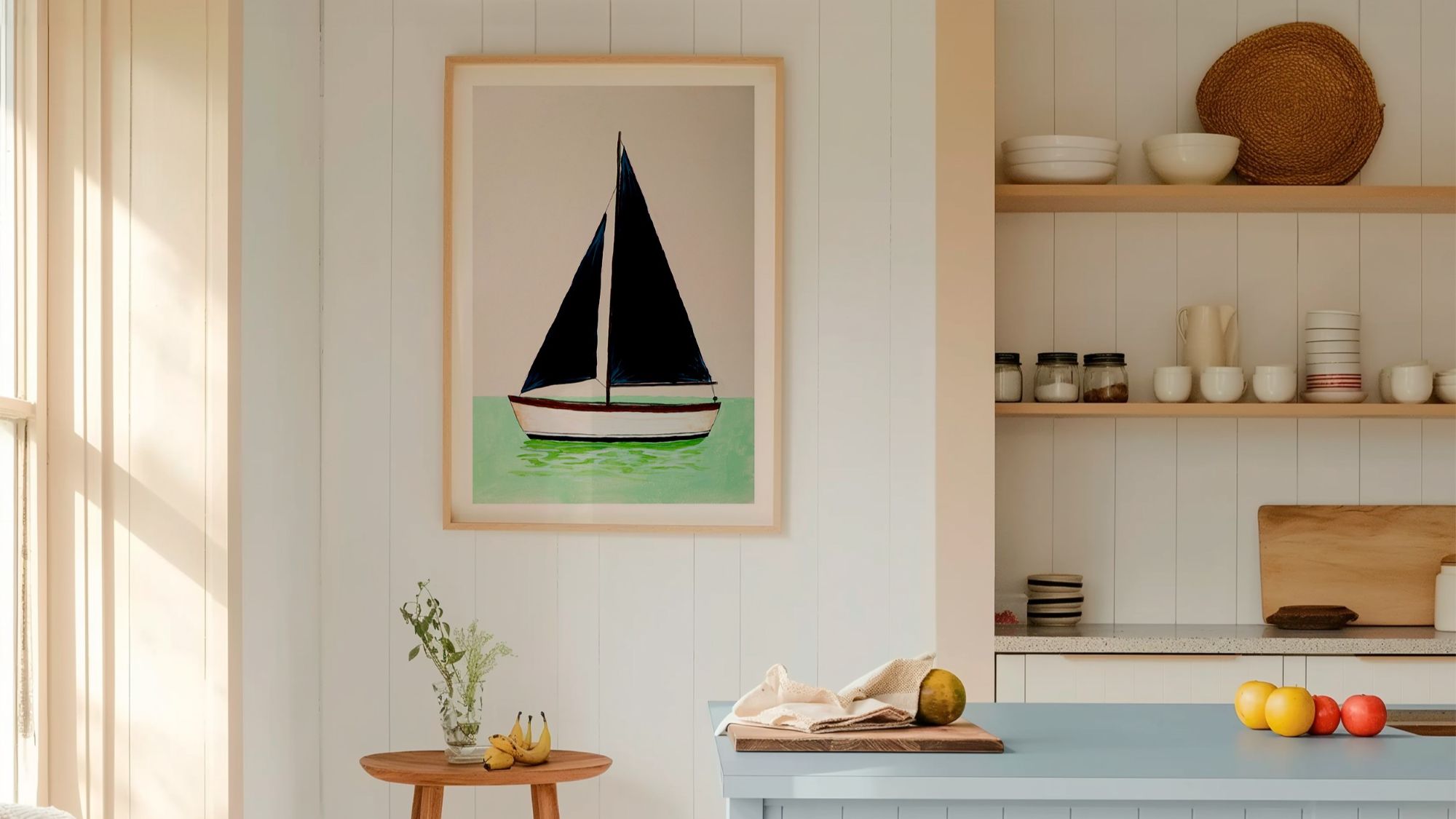 A framed art print of a minimalist sailboat with dark navy blue sails, floating on mint green water against a light beige background. The vertical print is housed in a light wood frame and hangs on a white, vertical-shiplap wall.
