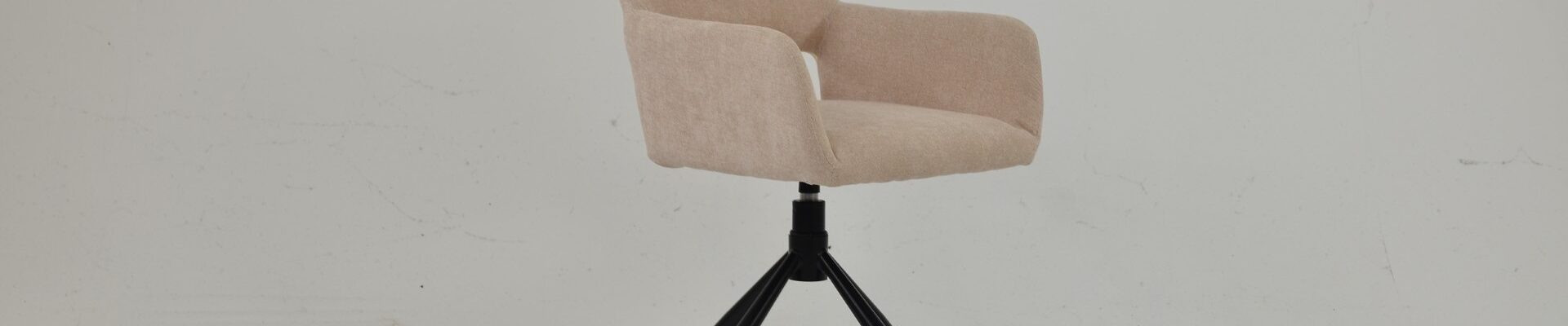 Odense swivel dining chair in natural cream fabric with an upholstered bucket seat and black splayed metal legs