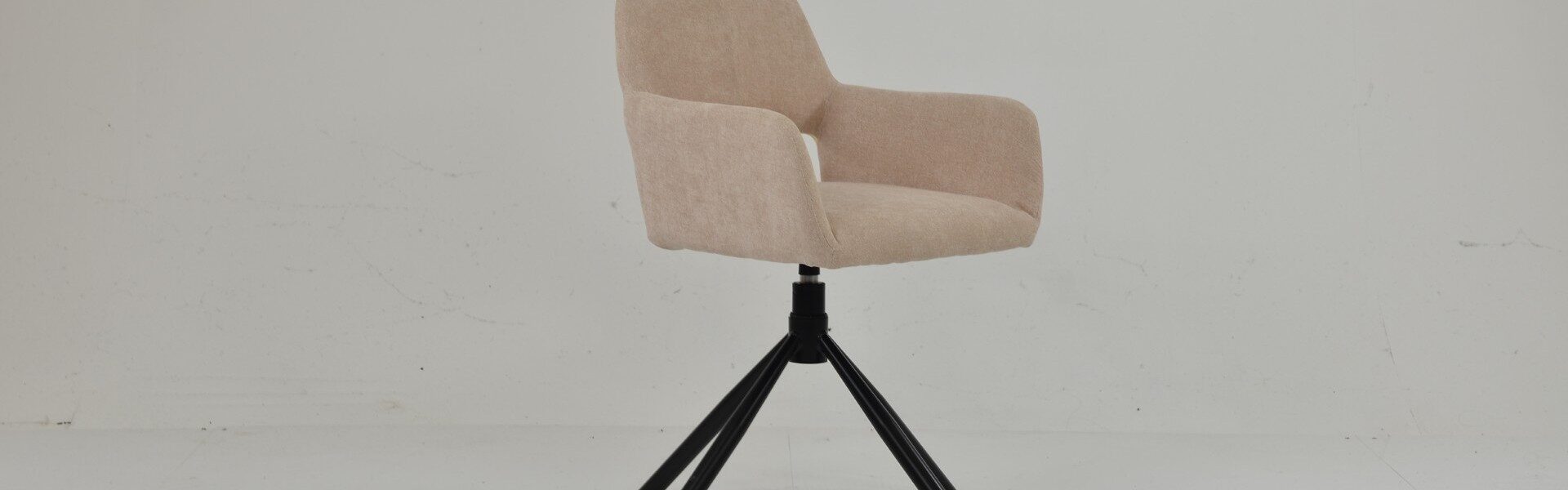 Odense swivel dining chair in natural cream fabric with an upholstered bucket seat and black splayed metal legs