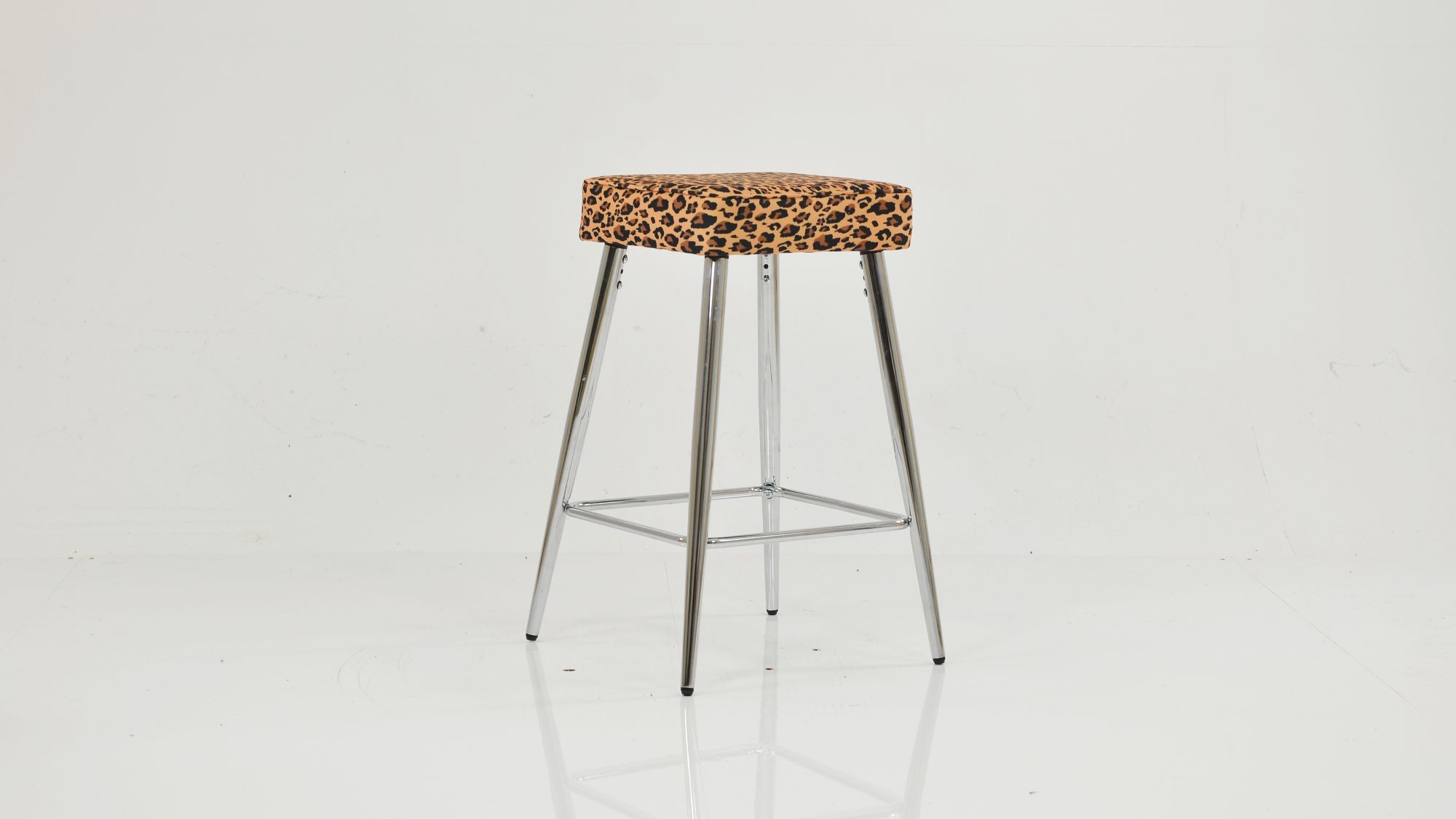 Modern bar stool featuring a square leopard print upholstered seat and polished chrome legs with a footrest.