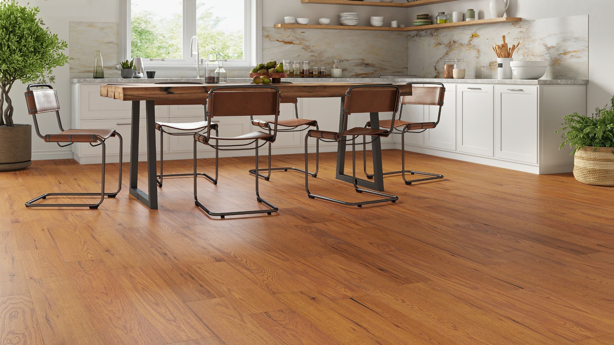Golden-brushed UV oiled oak engineered wood flooring installed in a bright modern kitchen with a rustic dining table and white cabinets.
